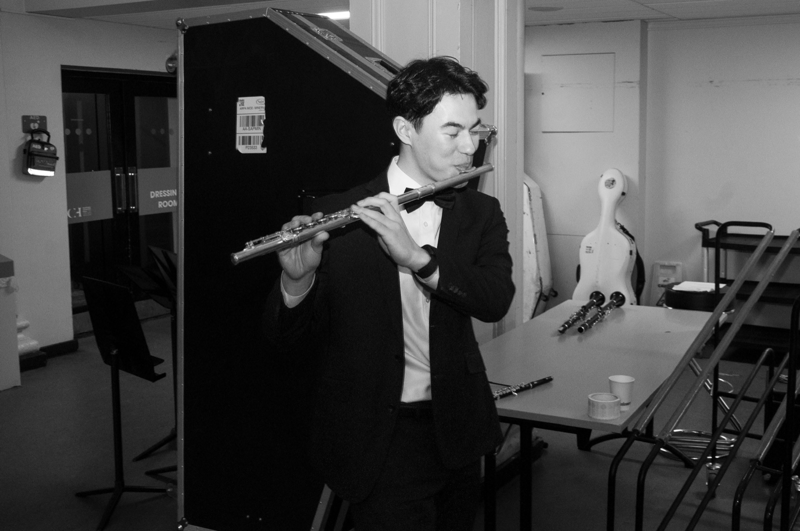 Keelan Reilly playing the flute backstage